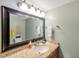 Bathroom featuring a large mirror, granite countertop, and decorative lighting at 7400 Sun Island S Dr # 206, South Pasadena, FL 33707