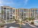 Multi-story condo building with multiple balconies, and lush landscaping at 7400 Sun Island S Dr # 206, South Pasadena, FL 33707