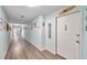 Well-lit hallway with wood floors and colorful wall decor at 7400 Sun Island S Dr # 206, South Pasadena, FL 33707