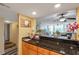 Kitchen with dark countertops that look out onto the living room and the beautiful waterfront view at 7400 Sun Island S Dr # 206, South Pasadena, FL 33707