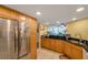 Kitchen with stainless steel refrigerator and dark countertops that look out onto the living room at 7400 Sun Island S Dr # 206, South Pasadena, FL 33707