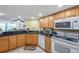 Kitchen features black granite counters, wooden cabinets and stainless appliances, offering functionality and style at 7400 Sun Island S Dr # 206, South Pasadena, FL 33707