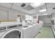 Bright laundry room with multiple washing machines and ample space for residents at 7400 Sun Island S Dr # 206, South Pasadena, FL 33707