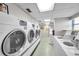 Clean laundry room featuring modern washing machines and well-lit interiors at 7400 Sun Island S Dr # 206, South Pasadena, FL 33707