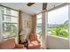 Bright seating area featuring waterfront views from oversized windows and comfortable chairs at 7400 Sun Island S Dr # 206, South Pasadena, FL 33707