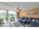 Bright living room featuring a large window with serene water views and greenery at 7400 Sun Island S Dr # 206, South Pasadena, FL 33707