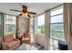 Cozy seating area featuring large windows with waterfront views and a ceiling fan at 7400 Sun Island S Dr # 206, South Pasadena, FL 33707