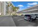Assigned covered parking with building in background on a sunny day at 7400 Sun Island S Dr # 206, South Pasadena, FL 33707