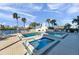 Community pool with a jacuzzi surrounded by palm trees at 7400 Sun Island S Dr # 206, South Pasadena, FL 33707