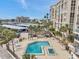 Resort-style pool and spa with lounge chairs in a waterfront condo community with beach access and parking at 7400 Sun Island S Dr # 206, South Pasadena, FL 33707