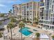 Condo community featuring a pool and spa area surrounded by palm trees and comfortable seating, perfect for relaxation at 7400 Sun Island S Dr # 206, South Pasadena, FL 33707