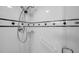 Clean shower featuring white tile and grab bars for a safe and accessible bathing experience at 7400 Sun Island S Dr # 206, South Pasadena, FL 33707