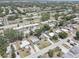 This aerial shot shows a community with a mix of housing, mature landscaping, and community amenities like a pool at 8358 Candlewood Rd, Seminole, FL 33777