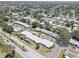 Aerial photo of homes in a tree-lined neighborhood with a mix of residential building styles and manicured landscaping at 8358 Candlewood Rd, Seminole, FL 33777