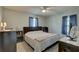 Cozy bedroom with large window, fan, and a comfortable bed and neutral toned decor at 8358 Candlewood Rd, Seminole, FL 33777