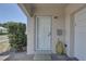 Well-maintained front door with a 'gather' welcome mat and a charming, homey feel at 8358 Candlewood Rd, Seminole, FL 33777