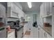 The kitchen offers white cabinets and a view to the dining area for easy entertaining at 8358 Candlewood Rd, Seminole, FL 33777