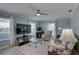 Bright living room featuring large windows, a ceiling fan, and comfortable seating area at 8358 Candlewood Rd, Seminole, FL 33777