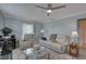 Comfortable living room features a ceiling fan, plush seating, and a neutral color palette at 8358 Candlewood Rd, Seminole, FL 33777