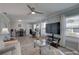 Open-concept living room features dining space and large windows for great natural light at 8358 Candlewood Rd, Seminole, FL 33777