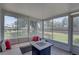 The spacious sunroom features tile floors, a ceiling fan, and access to the backyard at 8358 Candlewood Rd, Seminole, FL 33777