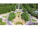 Aerial view of a neighborhood roundabout featuring trees and well-manicured landscaping at 8474 Dunham Station Dr, Tampa, FL 33647