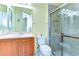 Well-lit bathroom featuring a glass-enclosed shower, tile floor, and a vanity sink at 8474 Dunham Station Dr, Tampa, FL 33647