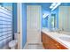 Bathroom featuring a double sink vanity, a toilet, and a shower with blue painted walls at 8474 Dunham Station Dr, Tampa, FL 33647
