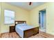 Bedroom with a bed, wood floor, and a glimpse into the bathroom; an inviting personal space at 8474 Dunham Station Dr, Tampa, FL 33647