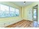 Bonus room featuring a bench with storage, a large window, and a doorway, creating a versatile space at 8474 Dunham Station Dr, Tampa, FL 33647