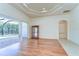 Versatile bonus room with hardwood flooring, crown molding, and direct access to the outdoor pool area at 8474 Dunham Station Dr, Tampa, FL 33647