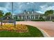 The Hampton Club's clubhouse featuring beautiful landscaping and well-manicured grounds at 8474 Dunham Station Dr, Tampa, FL 33647