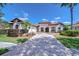 Stunning single-story home with a tile roof, manicured landscaping, and paved driveway at 8474 Dunham Station Dr, Tampa, FL 33647