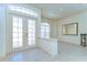 Bright foyer featuring tile flooring, a decorative mirror, and double glass doors providing an elegant entry at 8474 Dunham Station Dr, Tampa, FL 33647