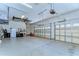 Spacious three car garage featuring epoxy flooring, two overhead doors, and ample storage at 8474 Dunham Station Dr, Tampa, FL 33647