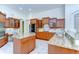 Open kitchen with granite countertops, custom cabinets, a kitchen island, stainless steel appliances, and tile floors at 8474 Dunham Station Dr, Tampa, FL 33647