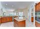 Bright open-concept kitchen featuring a kitchen island, granite countertops, tile floors, and modern appliances at 8474 Dunham Station Dr, Tampa, FL 33647