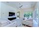 Spacious living room with comfortable seating, a modern entertainment center, and a serene view of the outdoors at 8474 Dunham Station Dr, Tampa, FL 33647