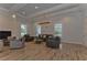 Comfortable lounge featuring ample seating, natural light, and a cozy fireplace at 8474 Dunham Station Dr, Tampa, FL 33647