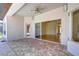 Covered outdoor patio with brick flooring offering a view of the home's interior through sliding glass doors at 8474 Dunham Station Dr, Tampa, FL 33647