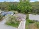 Aerial view of a home showcasing its well-manicured lawn, long driveway, and beautiful surroundings at 8600 Village Mill Row, Hudson, FL 34667