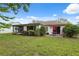 Wide backyard with plenty of green space and an open patio area at 8600 Village Mill Row, Hudson, FL 34667