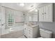 The bathroom offers a tiled shower, tub, vanity, and modern lighting at 8600 Village Mill Row, Hudson, FL 34667