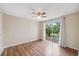 Bedroom features new floors, neutral paint, and sliding doors to patio at 8600 Village Mill Row, Hudson, FL 34667