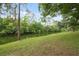 Scenic creek with lush green grass and trees lining the banks, creating a peaceful natural setting at 8600 Village Mill Row, Hudson, FL 34667