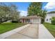 Charming one-story home features a well-maintained front lawn and an attached garage at 8600 Village Mill Row, Hudson, FL 34667