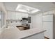 Clean kitchen with white cabinets, stainless steel appliances, and laminate countertops at 8600 Village Mill Row, Hudson, FL 34667