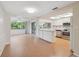 Bright kitchen with breakfast bar, stainless steel appliances, and white cabinets at 8600 Village Mill Row, Hudson, FL 34667