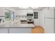 Bright kitchen features stainless steel appliances, white cabinets and a breakfast bar at 8600 Village Mill Row, Hudson, FL 34667