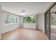 Bright living room featuring lots of windows and a sliding glass door at 8600 Village Mill Row, Hudson, FL 34667